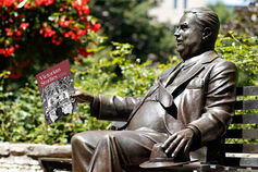 The Herman B Wells statue holds a Victorian Studies flyer.